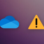 A OneDrive logo next to an alert icon